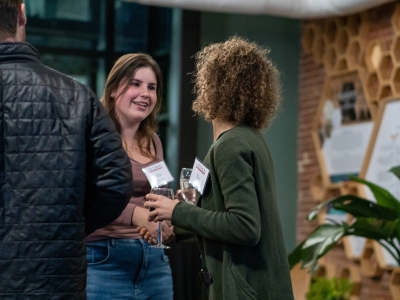 a young woman shakes the hand of an older woman in an office space