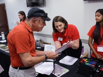 a young woman points at a map to an older man