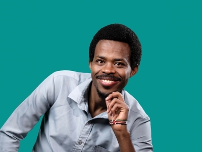 a young Black man wearing a collared shirt