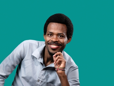 a young Black man wearing a collared shirt