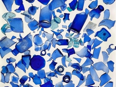 a collection of blue shards of glass on a white background