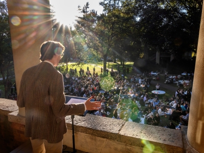 Student speaking at Eu Hall Balcony with students in the audience