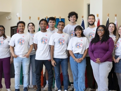 a group of students in matching t-shirts in an academic building