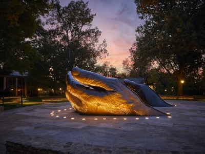 A sculpture of two hands rising out of the earth