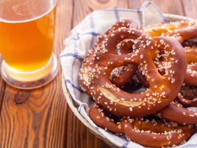 Soft Bavarian pretzels and beer on a wooden table