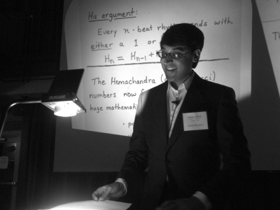 a mathematician presents a talk while using a projector