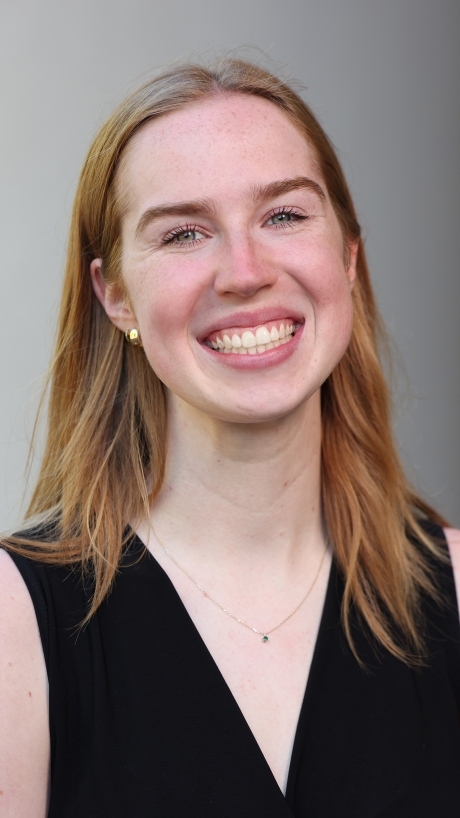 a young white woman with blonde hair wearing a black top