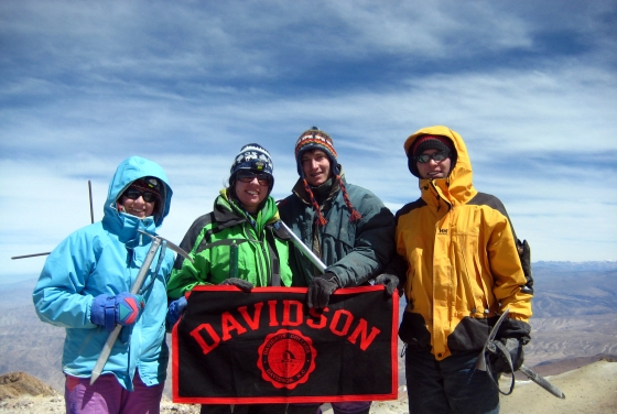 Davidson Flag with Students in Chachani Peru