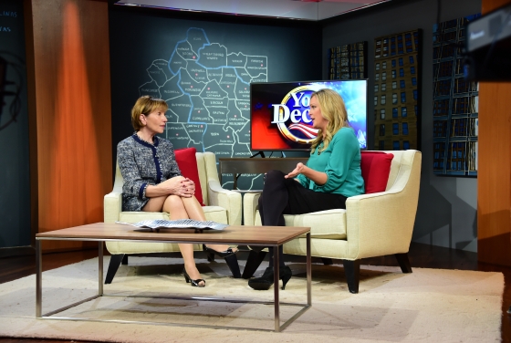 Prof. Susan Roberts on Fox Carolinas sits on a chair on a TV set, across from host