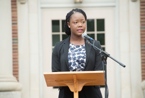Jocelyn Kennedy '17 stands at podium in front of Chambers for the Law School Induction Ceremony