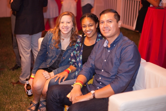 Three alumni sit together at a homecoming event