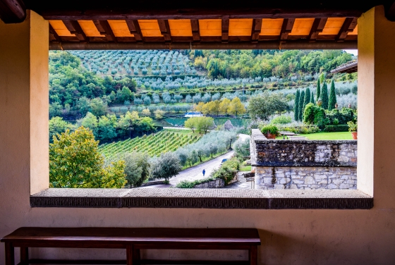 View of an Italian villa through an open window, showing the country side