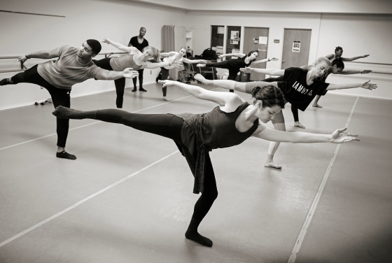Students take complex dance pose during a masterclass