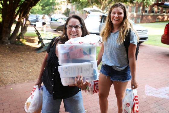 Student and her family member unload the car