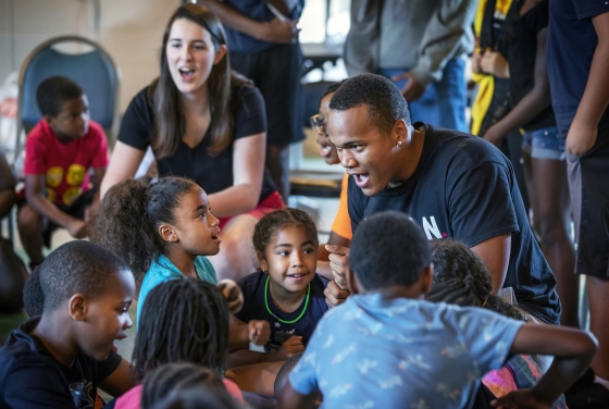 Students lead singing with kids from Freedom Schools