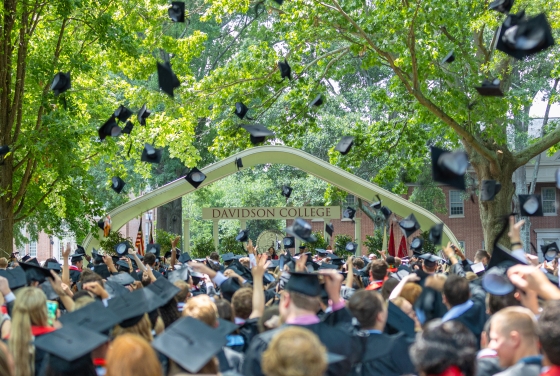 Davidson College Commencement Carol in the background as students throw up their caps