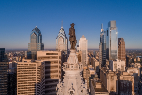 Philadelphia skyscrapers with Penn statue in foreground and blue skies in background