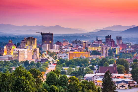 Asheville, NC skyline with mountains and sunset in background