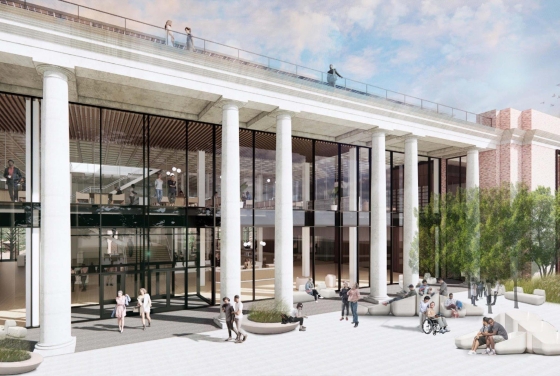 a modern looking library with white columns and green trees
