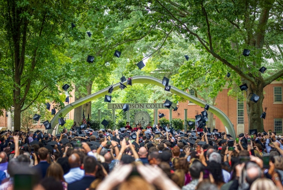 students throwing their caps in the air at commencement