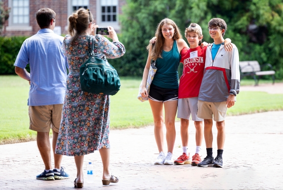 Family taking group photo at farewell picnic