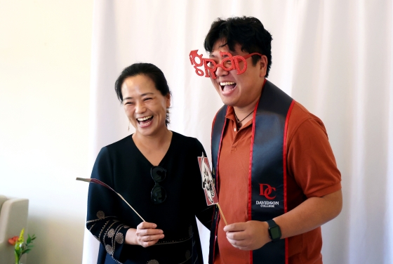 a young man with his mom smiling