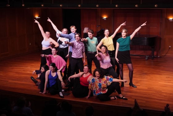 a group of young people smile and pose on a stage