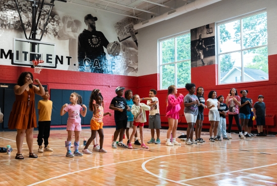 a group of young people play games in a gym
