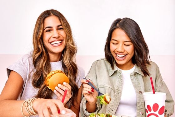 two women eating sandwiches and salads from chick-fil-a