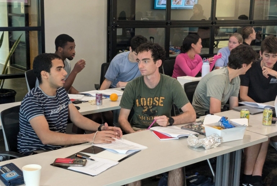 Students at a long table in a DCI Training session
