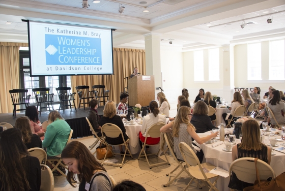 Women's Leadership Conference presentation with attendees at tables
