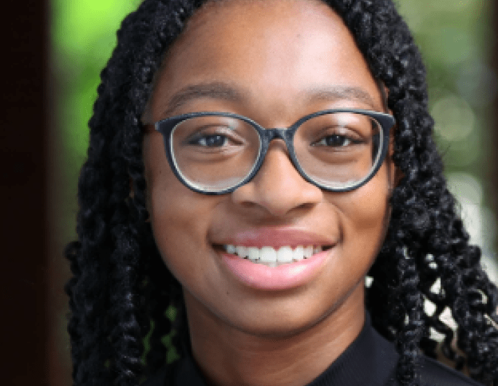 a young Black woman wearing glasses