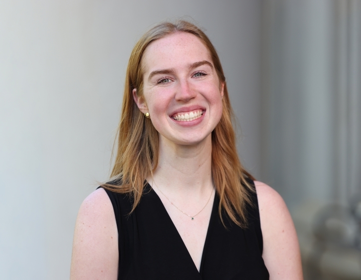 a young white woman with blonde hair wearing a black top