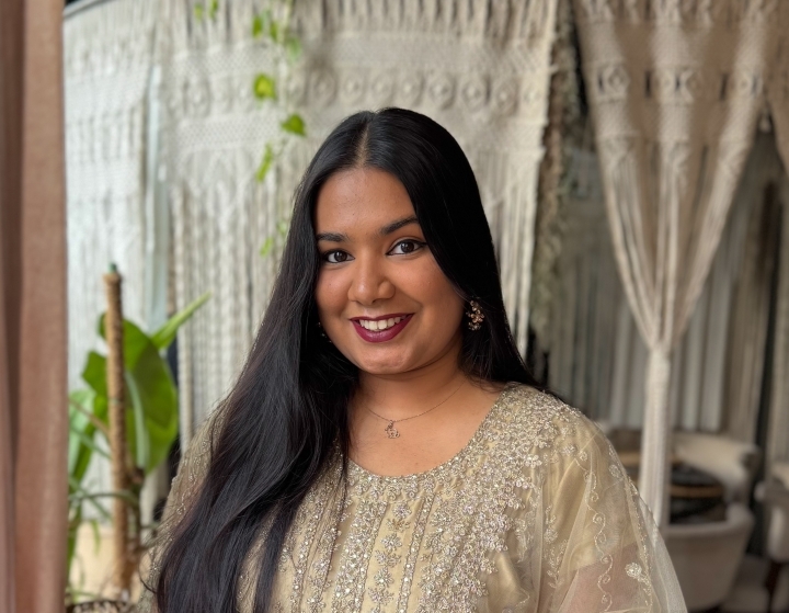 a young woman with long dark hair smiling