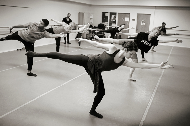 Students take complex dance pose during a masterclass
