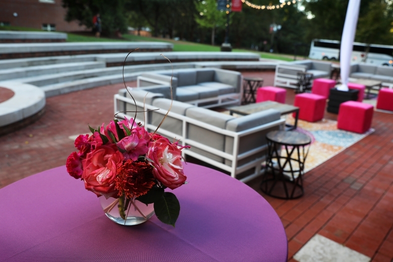Event with colorful table cloths and pink flowers