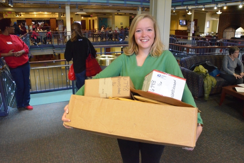 Student holds three packages