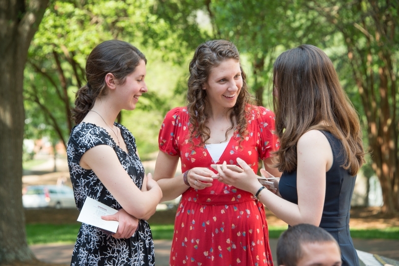 Students talk in small group at a Dean Rusk student gathering outside