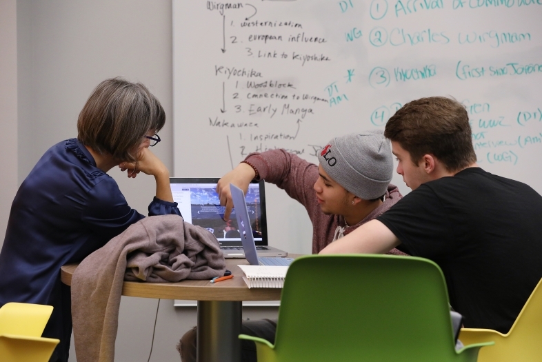 Prof. Churchill and Students Looking at Laptop