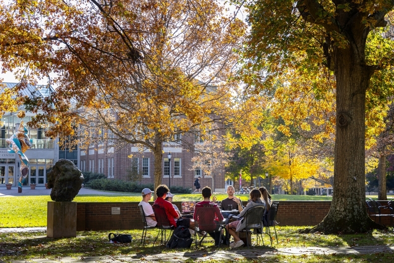 Prof. Patricio Boyer and Students gather outside on a beautiful fall day