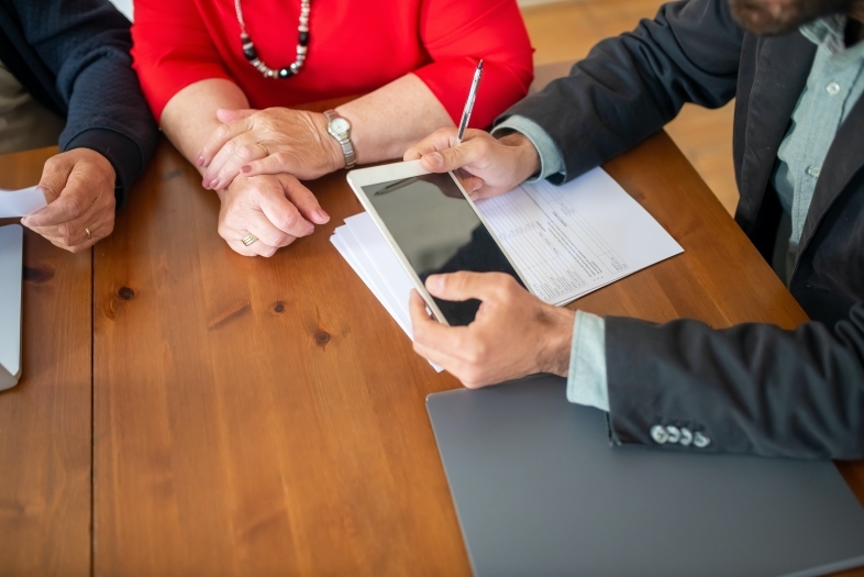 People signing papers