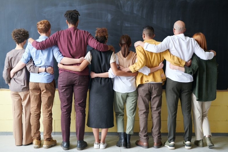 group of people with their arms around each other