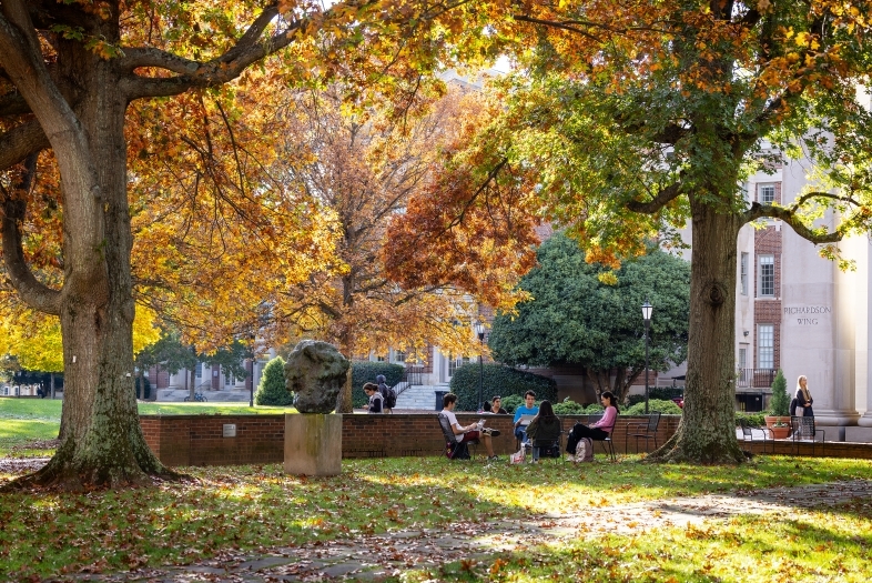 campus scene in front of colorful trees