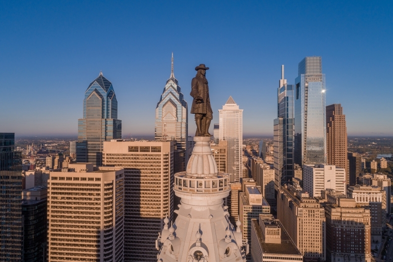 Philadelphia skyscrapers with Penn statue in foreground and blue skies in background