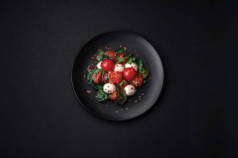 Caprese salad on black tablecloth