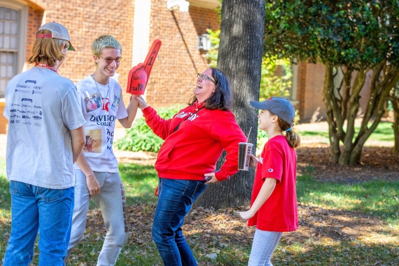a family in Davidson College gear standing around and smiling