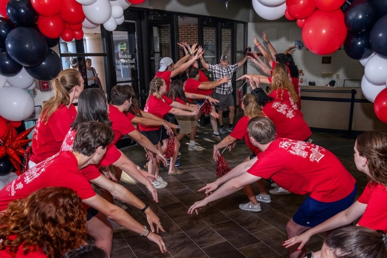Orientation opening session with existing students greeting new students