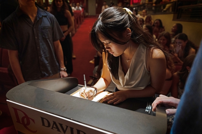 Honor Code Signing 2025 student signs her name