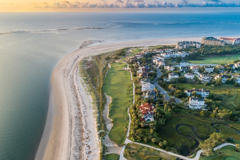 a beach at sunrise from aerial perspective