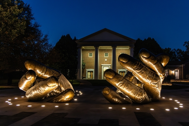 With These Hands Memorial illuminated at night